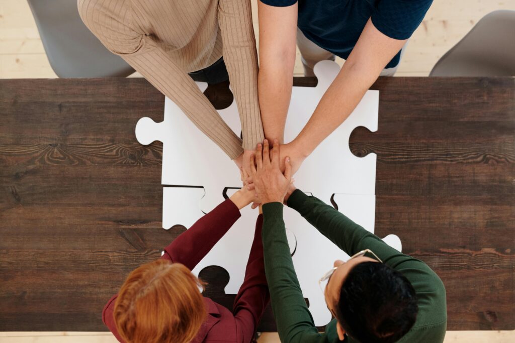 Engaging image of diverse people's hands coming together on puzzle pieces, symbolizing unity.